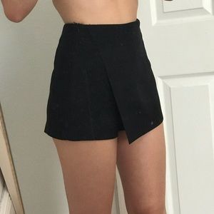 A pair of black suede Forever 21 skort